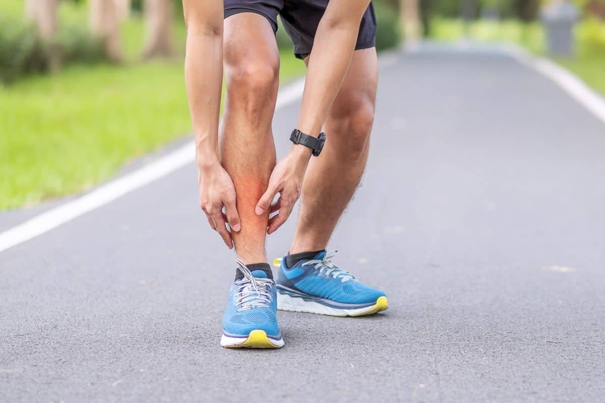 Man jumping with arms and legs out stretched stock photo - OFFSET